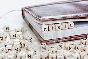 Word CIVIL on old wooden table.