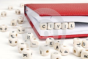 Word Civil written in wooden blocks in notebook on white wooden