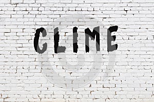 Word clime painted on white brick wall photo