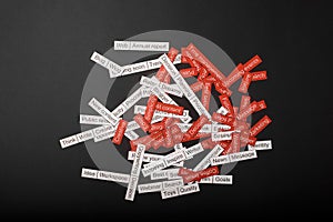 Word cloud of business themes cut out of red and white paper on a gray background