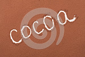 Word cocoa written in cocoa powder as background