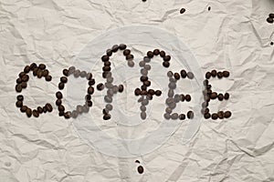 A word `Coffee` is laid out by coffee grains