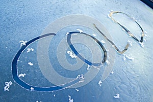 Word cold written on frosty windscreen