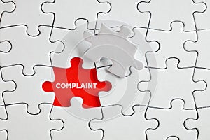 The word complaint on the missing puzzle piece. To discover or expose customer complaints