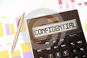 Word CONFIDENTIAL on calculator. Business and tax concept