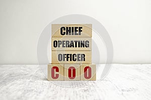 word COO on wooden blocks, white background, business concept. business and Finance