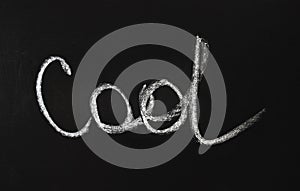 The word cool written in white chalk on a black chalkboard