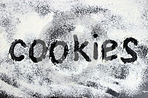 The word coolies is drawn with finger on the flour