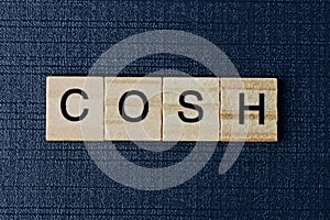 Word cosh from gray wooden letters photo