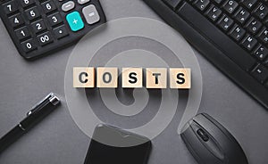 Word Costs on wooden cubes and business objects