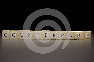 The word COUNTERPART written on wooden cubes isolated on a black background