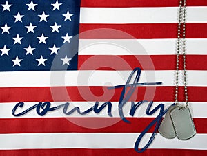 Word country and dog tags on flag