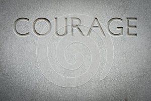 The Word Courage Engraved Into Rock