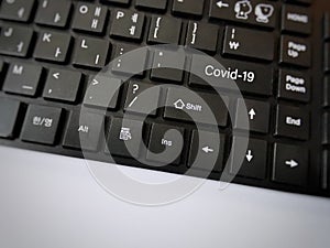 Word Covid-19 on komputer keyboard. Selective focus.