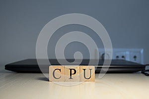 The word CPU is written. Computer and headset in the background. Closeup.