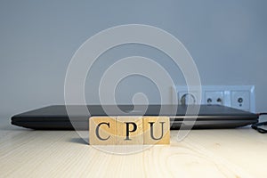 The word CPU is written. Computer and headset in the background. Closeup.