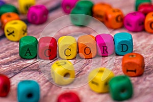 Word created with colored wooden cubes.