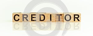 the word CREDITOR written on wooden cubes isolated on a white background