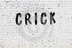 Word crick painted on white brick wall