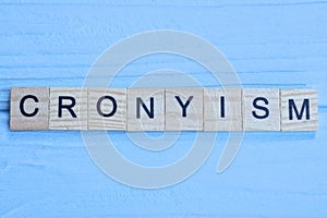 word cronyism made of small gray wooden letters