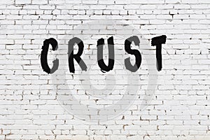 Word crust painted on white brick wall