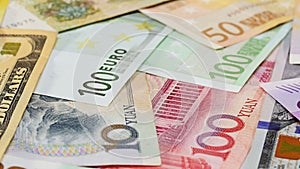 Word currency Yuan, US Dollar and Euro bank notes business background