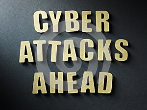 The word Cyber Attacks Ahead on paper background