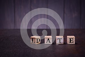 The word date late on wooden cubes, on a dark background, light wooden cubes signs, symbols signs