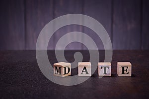 The word date mate on wooden cubes, on a dark background, light wooden cubes signs, symbols signs