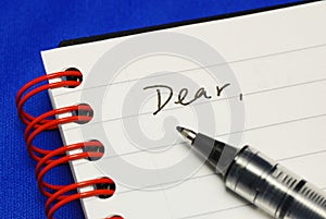 The word Dear with a pen photo