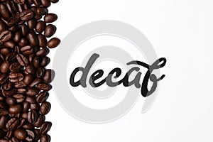 Word Decaf and coffee beans on white background, top view