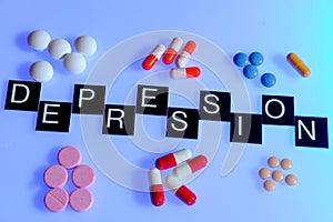 Word depression surrounded by medication photo