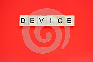 Word device. Top view of wooden blocks with letters on red surface