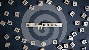 The word different written with wooden cube letters