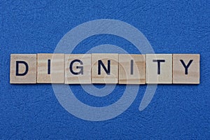 word dignity from small gray wooden letters
