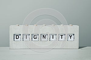 Word dignity in a wooden split flap board