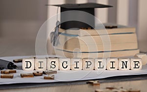 Word DISCIPLINE composed of wooden dices