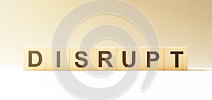 Word DISRUPT made with wood building blocks