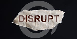 word DISRUPT on a piece of brown paper photo