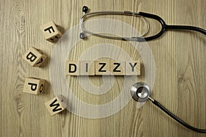 Word dizzy from wooden blocks with stethoscope