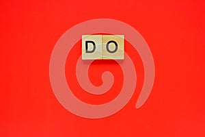 Word do. Top view of wooden blocks with letters on red surface