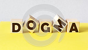 Word DOGMA made from building on light background