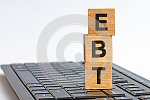 Word EBT made with wood building blocks on the keyboard, stock image