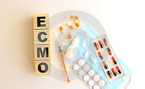 The word ECMO is made of wooden cubes on a white background. Medical concept