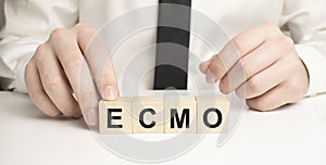 The word ecmo is written on wooden cubes . Medical concept