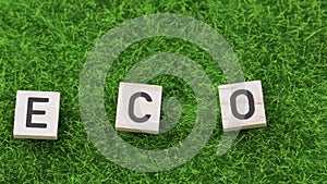 Word ECO composed on an artificial grass.