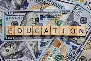 The word education on dollar usa background. College credits, graduation funds, tuition money concept.