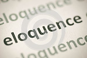 Word eloquence printed on paper macro photo
