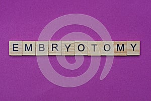 Word embryotomy from small gray wooden letters