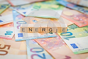 The word Energie - in German for Energy - written on banknotes Euro notes with wooden cube